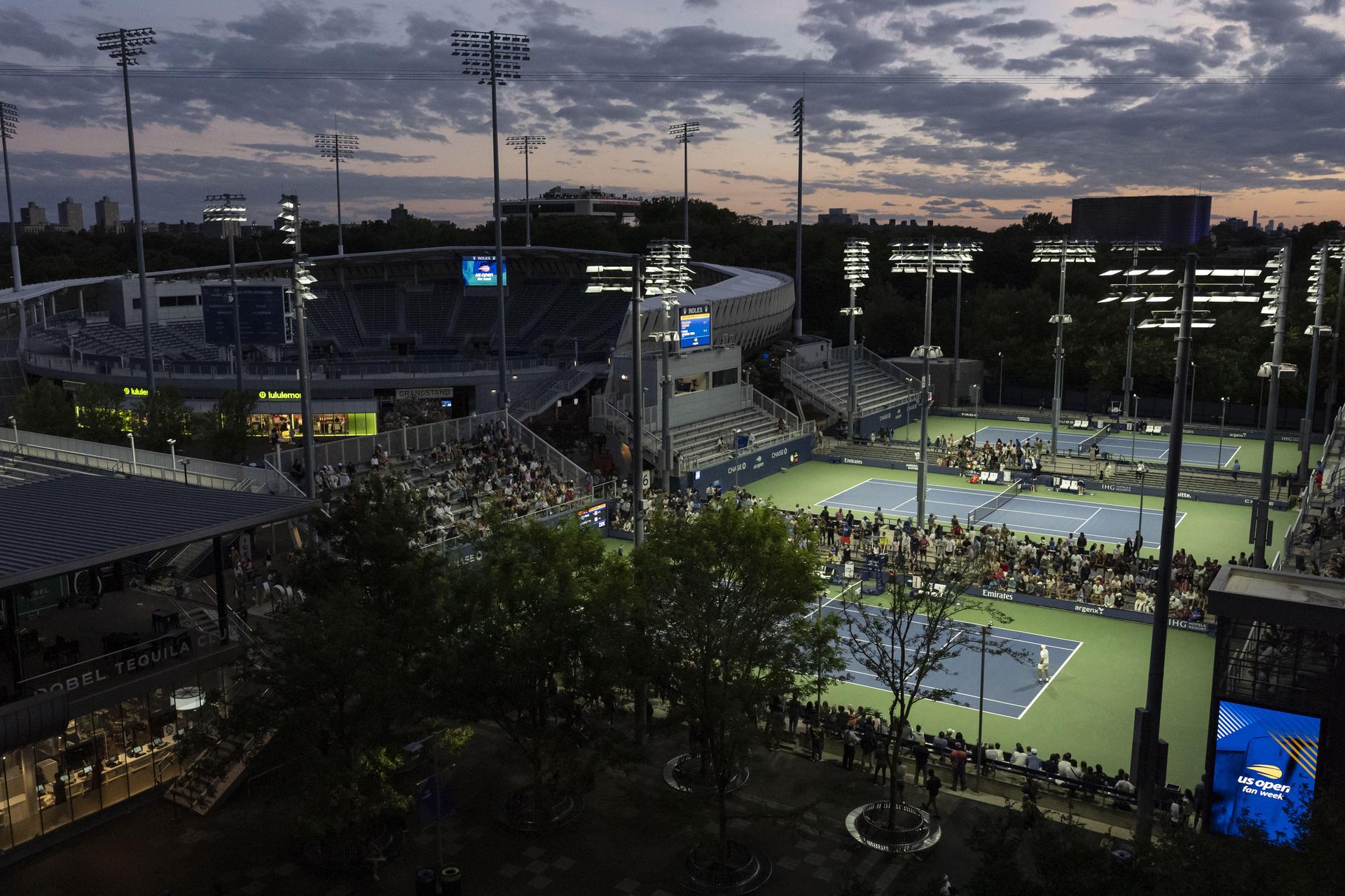 Shielded LED lights shine over the tennis courts during the U.S. Open tennis championships Tuesday in New York. (AP Photo/Yuki Iwamura)