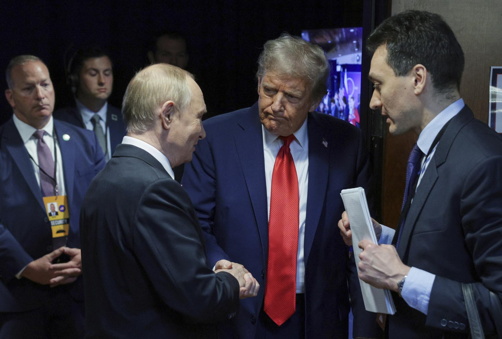U.S. President Donald Trump, second right, shakes hands with Russian President Vladimir Putin after their joint news conference on Friday at Joint Base Elmendorf-Richardson, Alaska. (Gavriil Grigorov, Sputnik, Kremlin Pool Photo via AP)