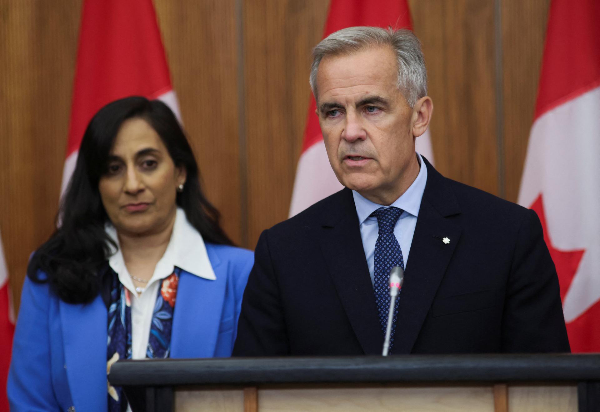  Canada's Prime Minister Mark Carney speaks at a press conference about recognizing Palestinian statehood, while Foreign Affairs Minister Anita Anand listens