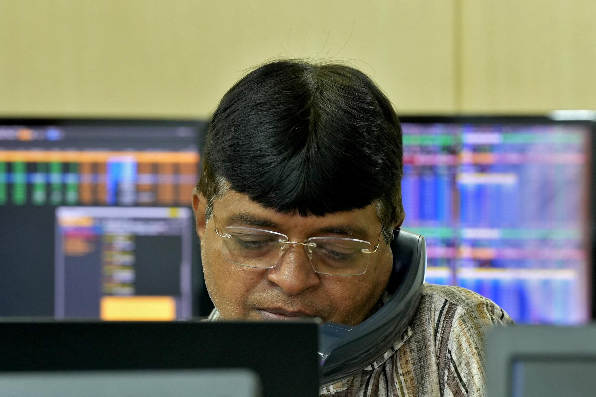 A broker speaks on his phone in Mumbai, India