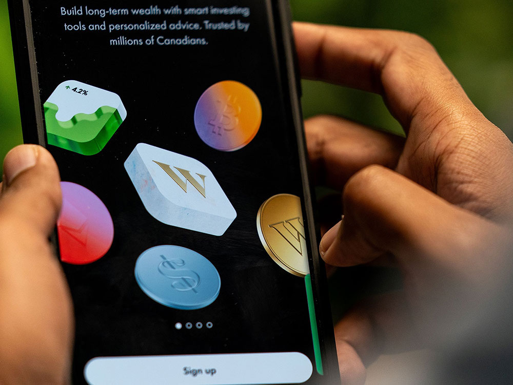 The load screen of the Wealthsimple app is shown on a phone.