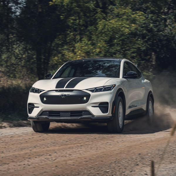white car driving on dirt road
