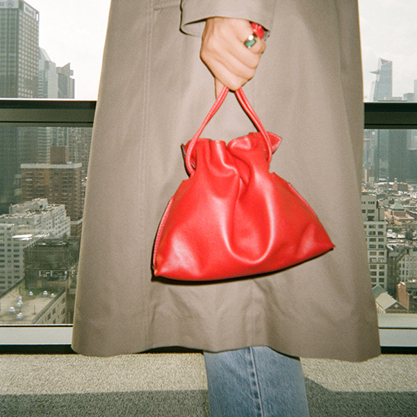 trench coat with red cinched handbag