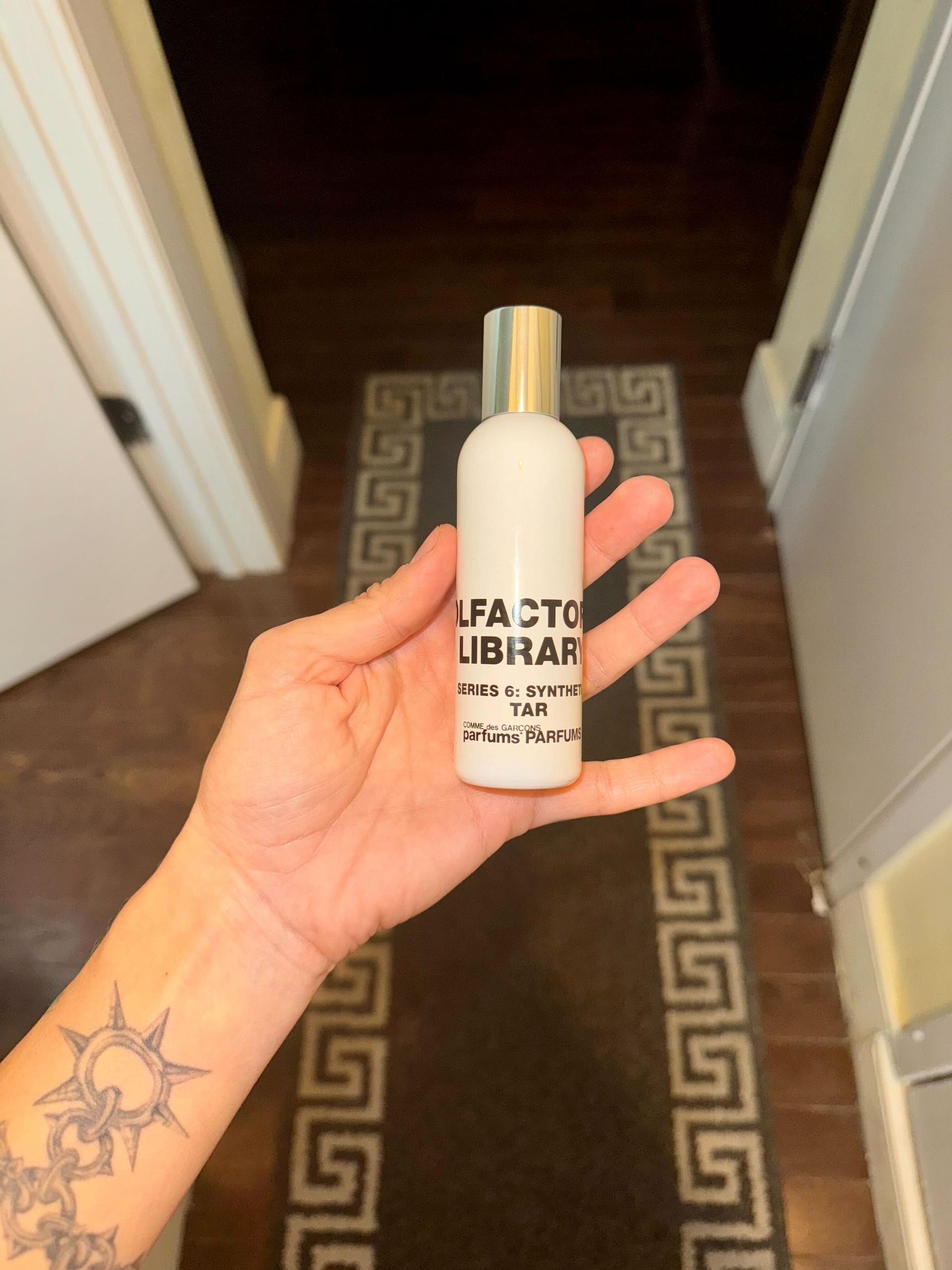 Image may contain: Bottle, Cosmetics, Perfume, Person, and Baby