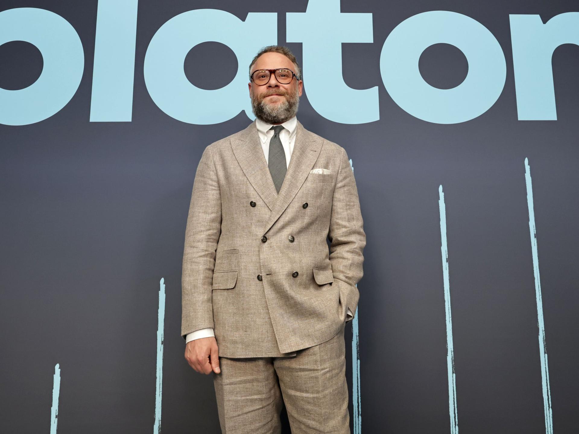 Image may contain: Seth Rogen, Clothing, Coat, Jacket, Blazer, Formal Wear, Suit, Adult, Person, People, Accessories, and Tie