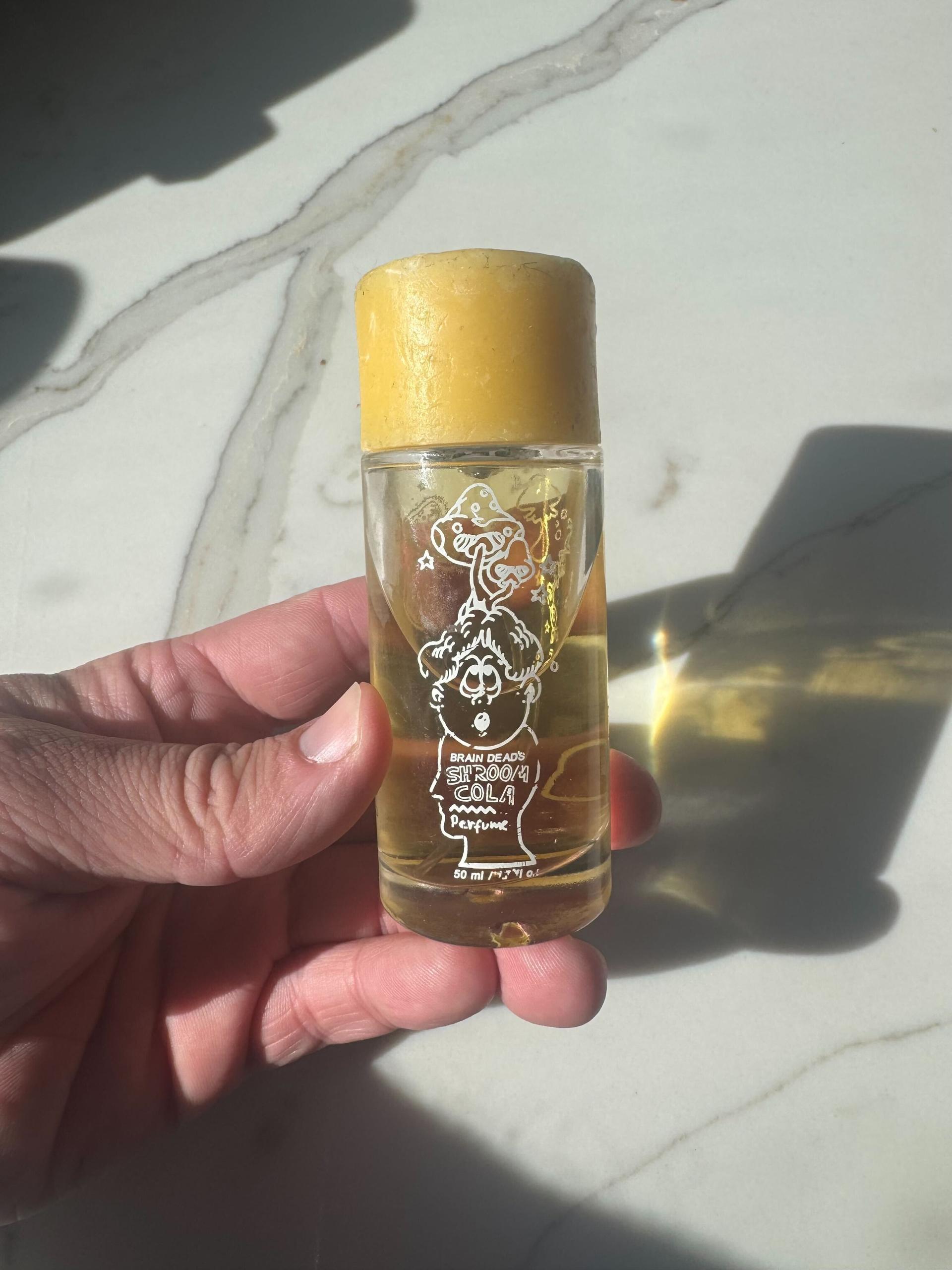 Image may contain: Bottle, Cosmetics, Perfume, Person, and Baby