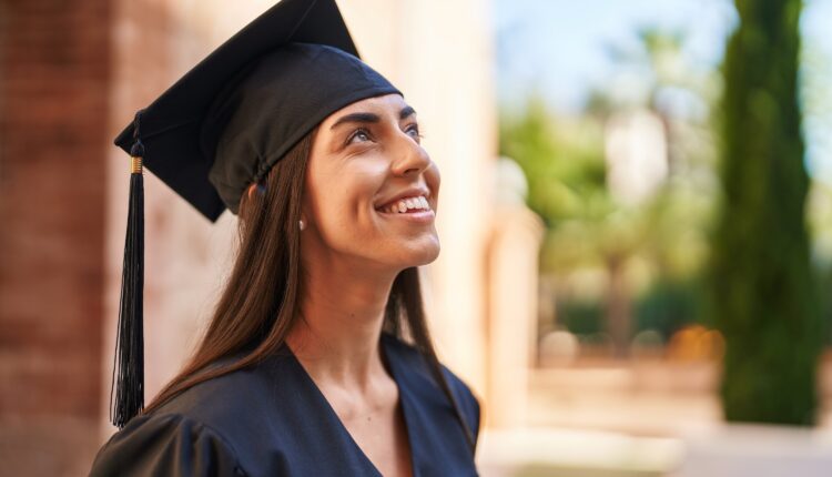 graduating student smiling in her cap and gown