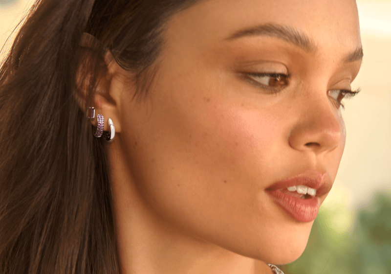 A woman reveals a stack of earrings