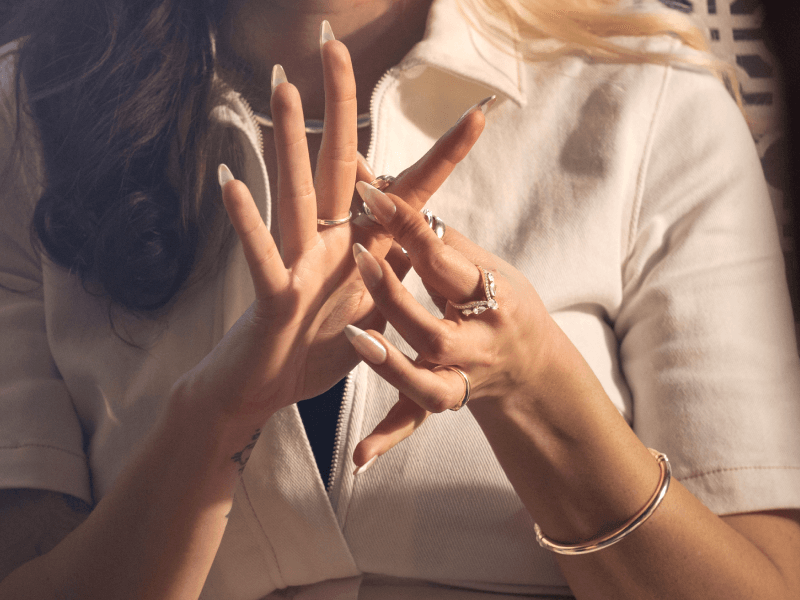 A woman places a ring on her index finger