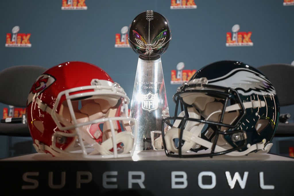 Kansas City Chiefs and Philadelphia Eagles helmets surrounding the Vince Lombardi trophy.