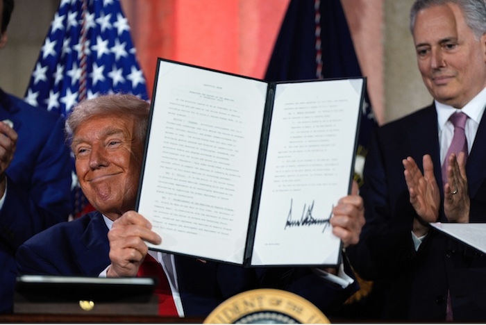 President Donald Trump signs an executive order on AI at the Andrew W. Mellon Auditorium in Washington, DC. Julia Demaree Nikhinson/AP