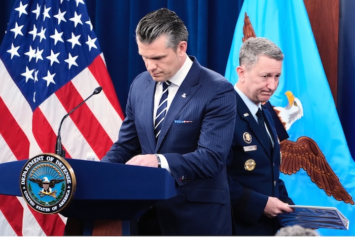 Defense Secretary Pete Hegseth and Joint Chiefs Chair Gen. Dan Caine at a Pentagon news conference on Sunday. Alex Brandon/AP