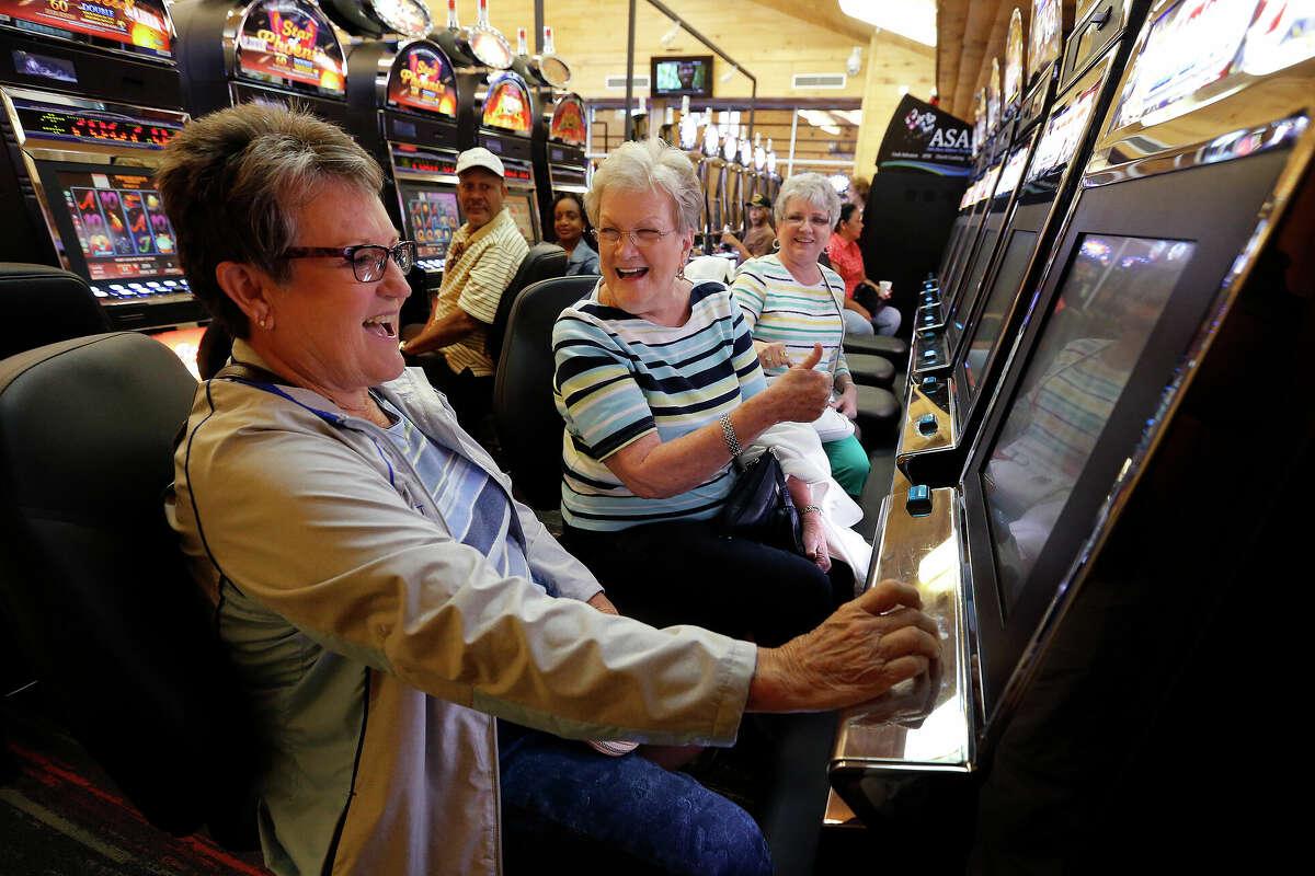 Trinity, Texas resident Shirley Sheffield (center) reacts as Patti Rau (left) wins on a gaming machine as their friend Jan Pistole watches on at Naskila Entertainment in Livingston, Texas on Tuesday, June 7, 2016.