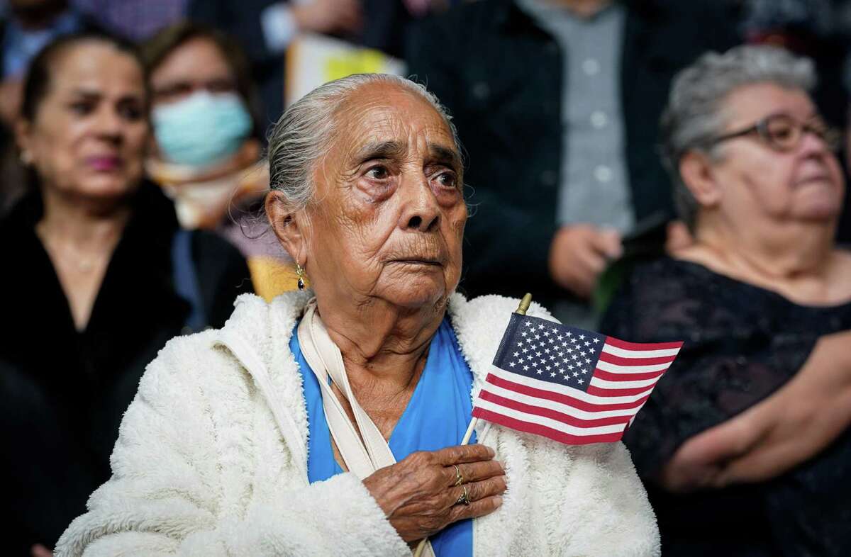 Catalina Nava stands for the pledge of allegiance after she became a United States citizen during a naturalization ceremony on Wednesday, Jan. 11, 2023, at M.O. Campbell Educational Center in Houston. Nava, originally from Mexico, was among nearly 1,800 people who became U.S. citizens at the ceremony.