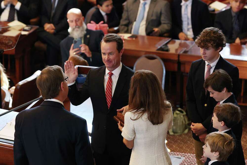 With his wife, Kim holding the bible and his sons by his side, Texas State Rep. Dade Phelan is sworn in as Speaker of the House for the 88th Legislature by Jefferson County Judge Jeff Branick at the State Capitol, Tuesday, Jan. 10, 2023.