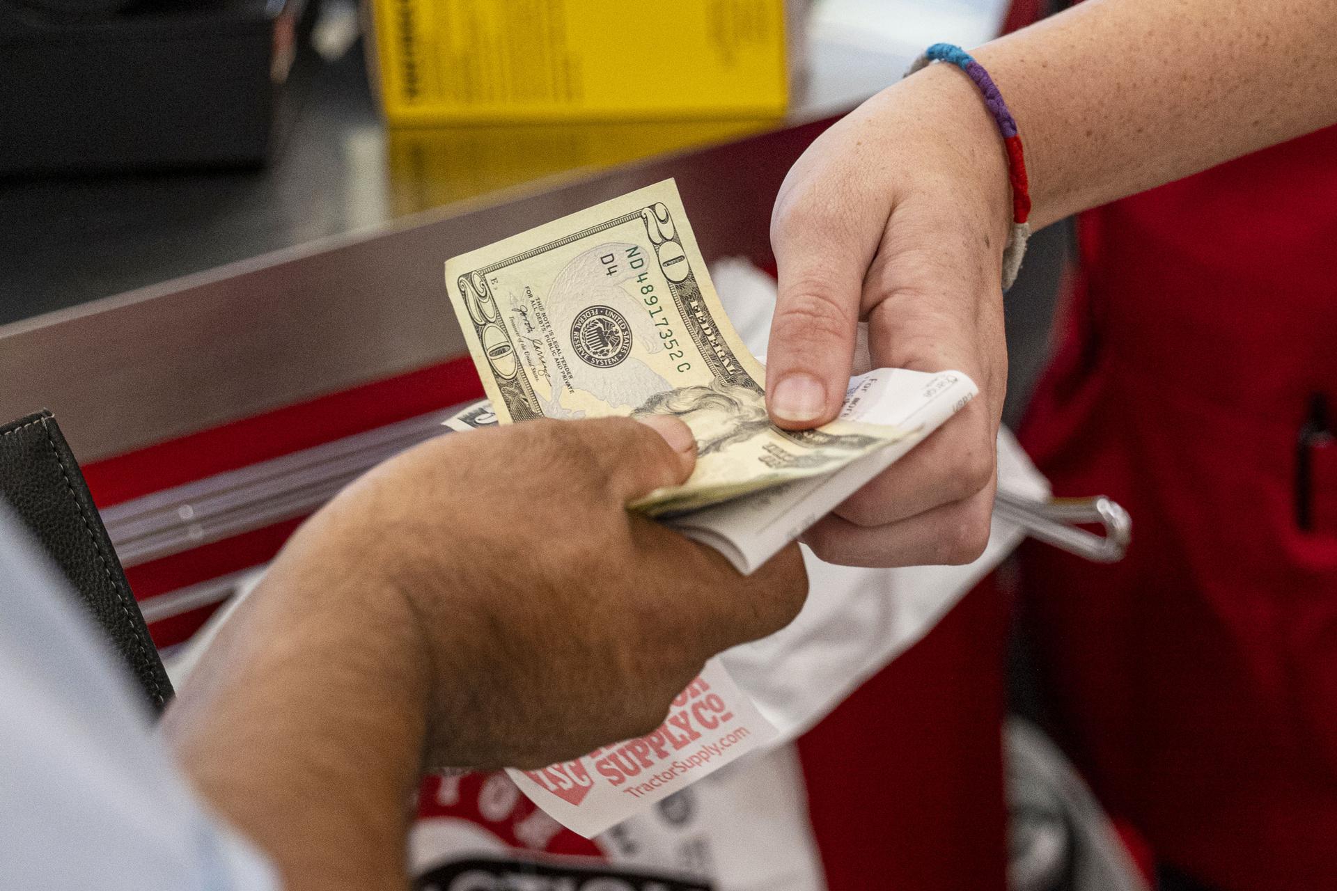 Money changing hands. Credit: Bloomberg via Getty Images