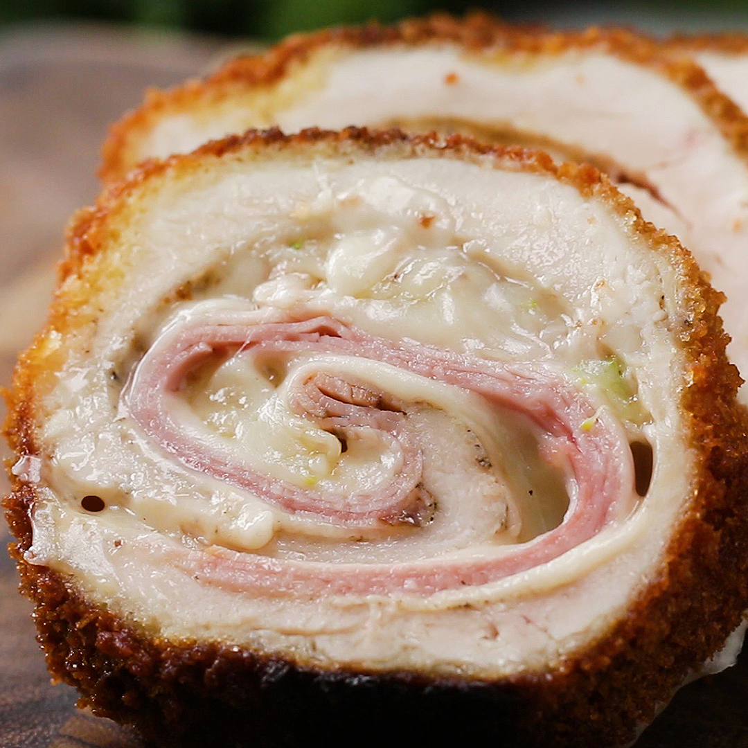stacked slices of crispy rolled chicken filled with ham and cheese