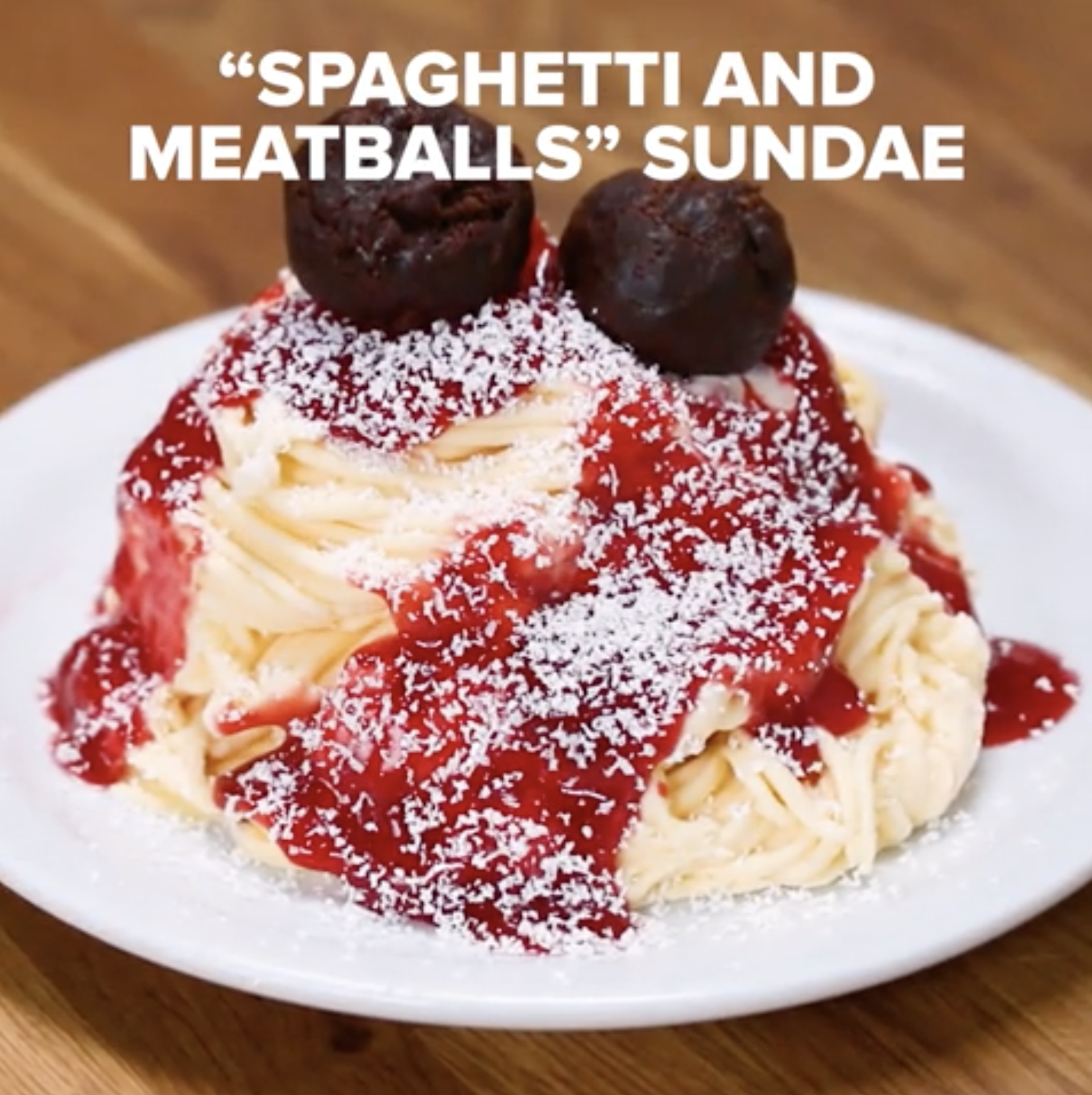 A pile of ''ice cream noodles'' covered in strawberry sauce, fresh strawberries, white chocolate shavings, and brownie ''meatballs'' A pile of ''ice cream noodles'' covered in strawberry sauce, fresh strawberries, white chocolate shavings, and brownie ''meatballs''