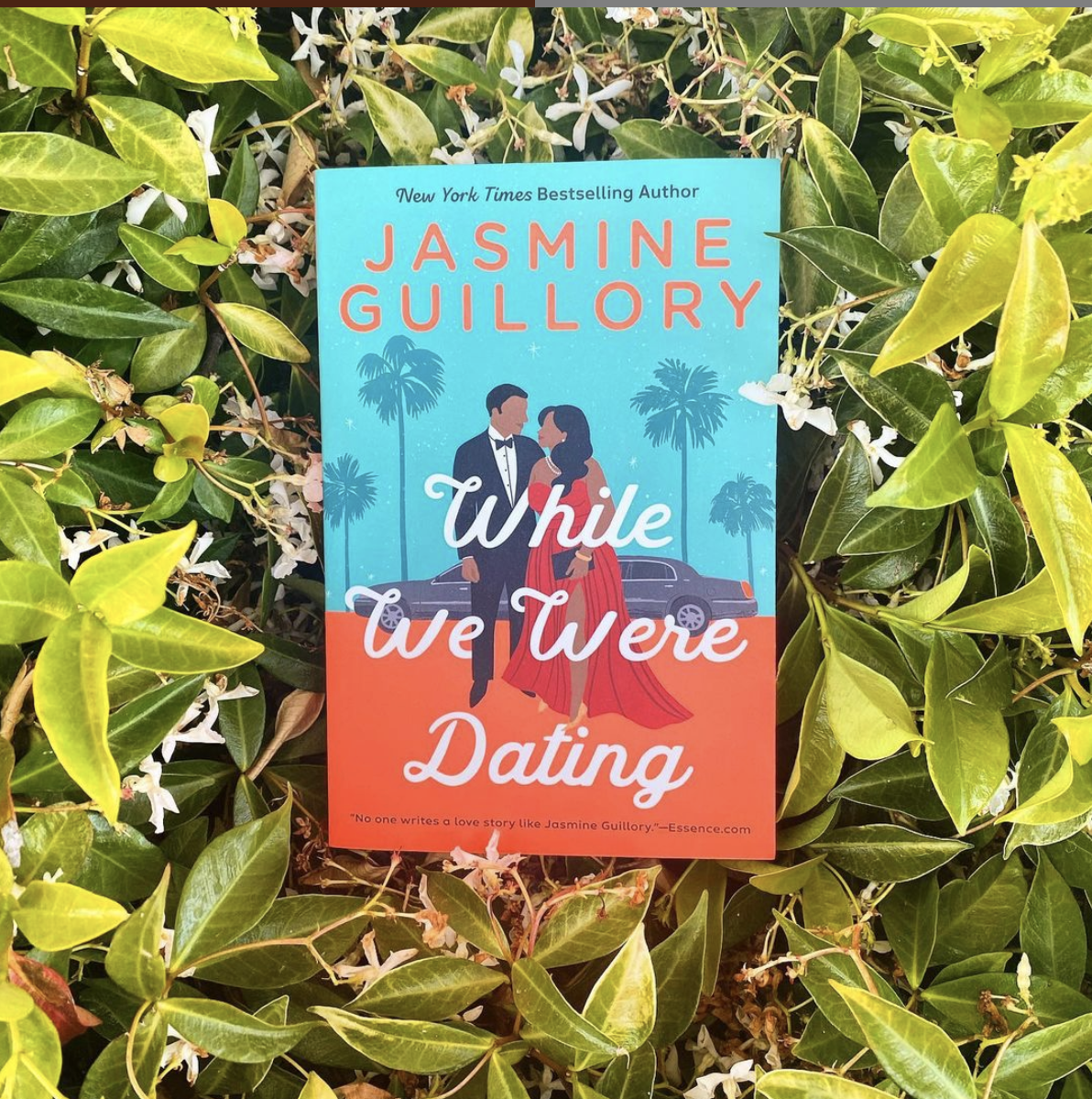 a copy of ''while we were dating'' sits amidst a beg of jasmine and green leaves