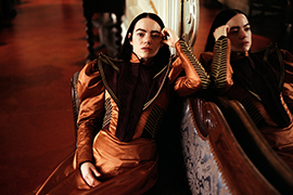 Emma Stone posing for a photo wearing a dress.