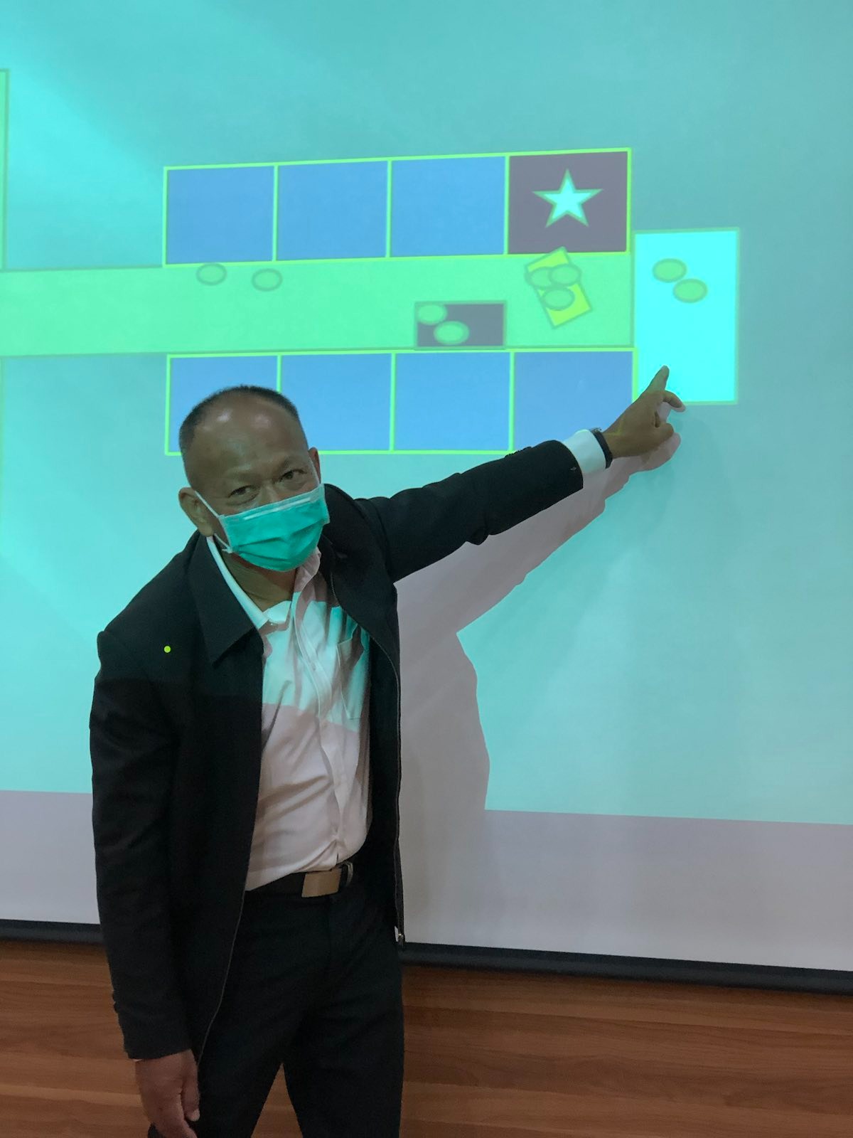 Thai team leader Colonel Pisal Erb-Arb, pointing to a map on the wall