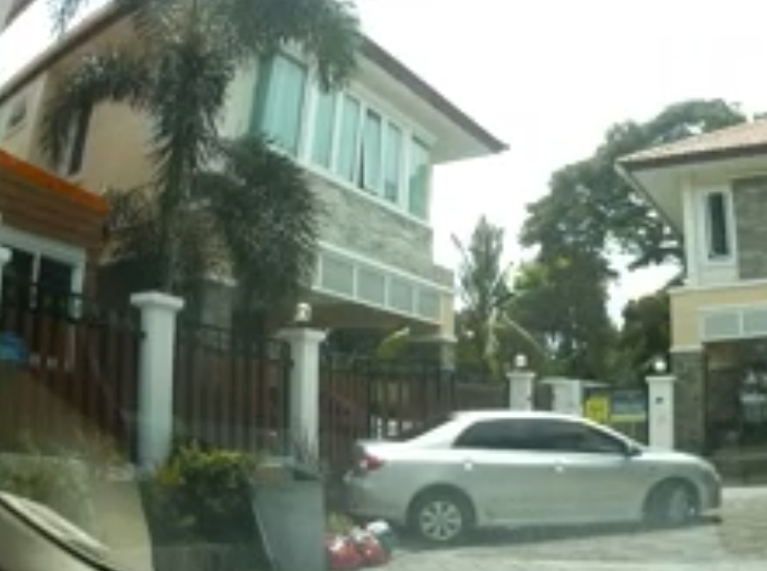 A still from a video showing a gray Toyota Camry crashing into Cazes' gate