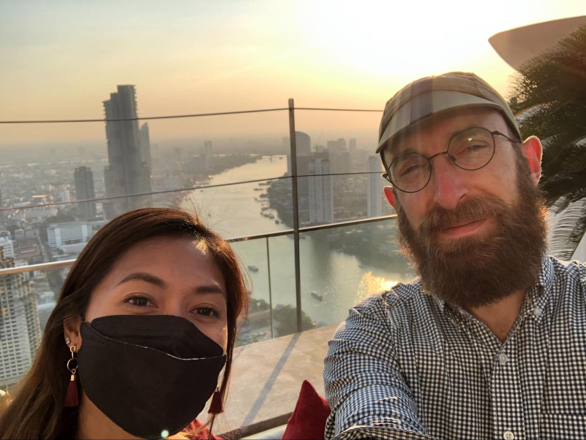 A monitor lizard in the grass near some water in Thailand