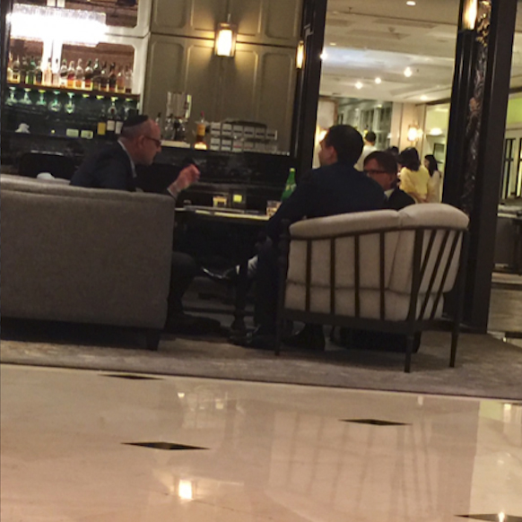 Close up surveillance footage of Cazes sitting with the Israeli businessmen