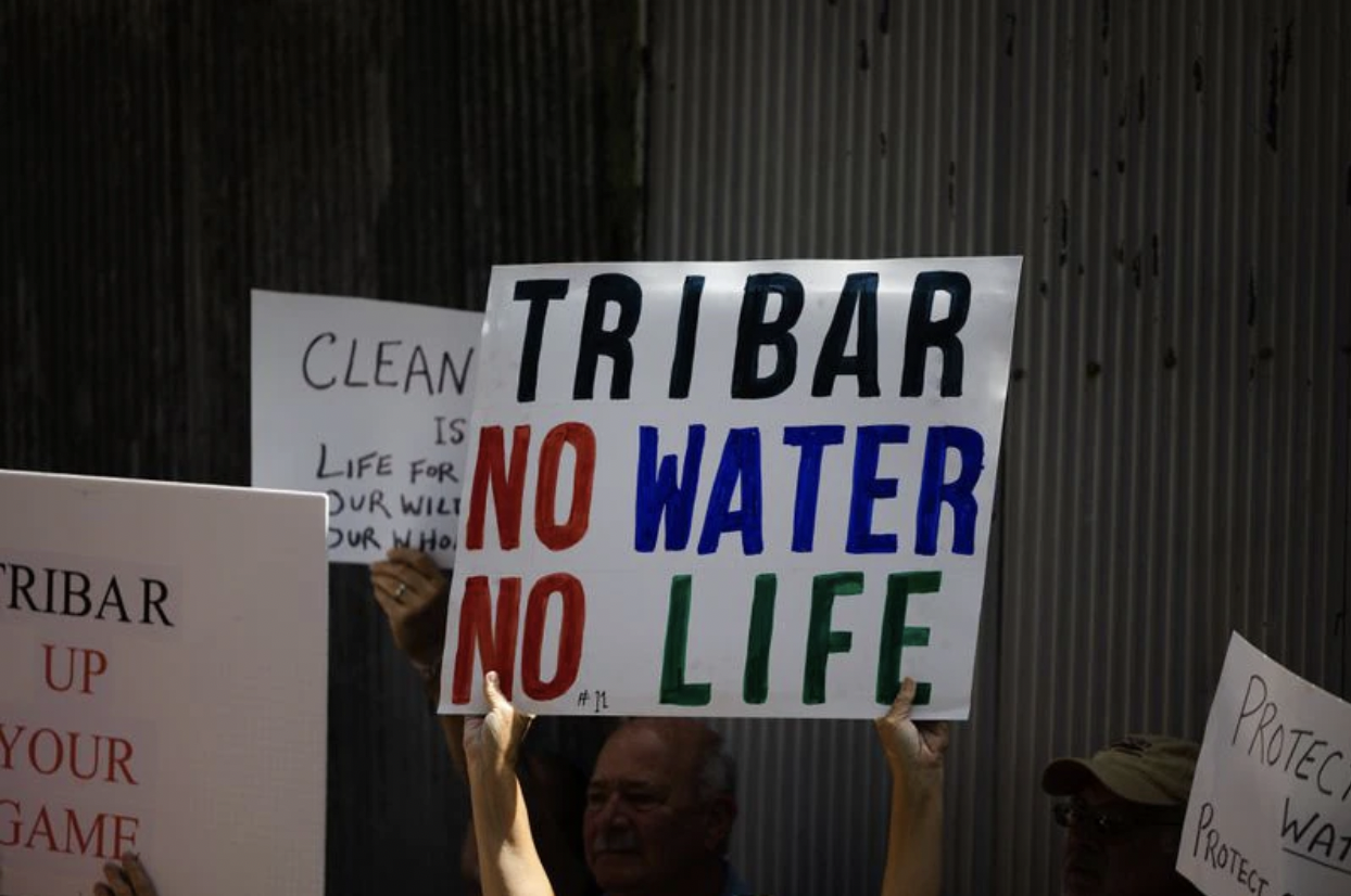 Protest sign reads ''Tribar, no water, no life.''