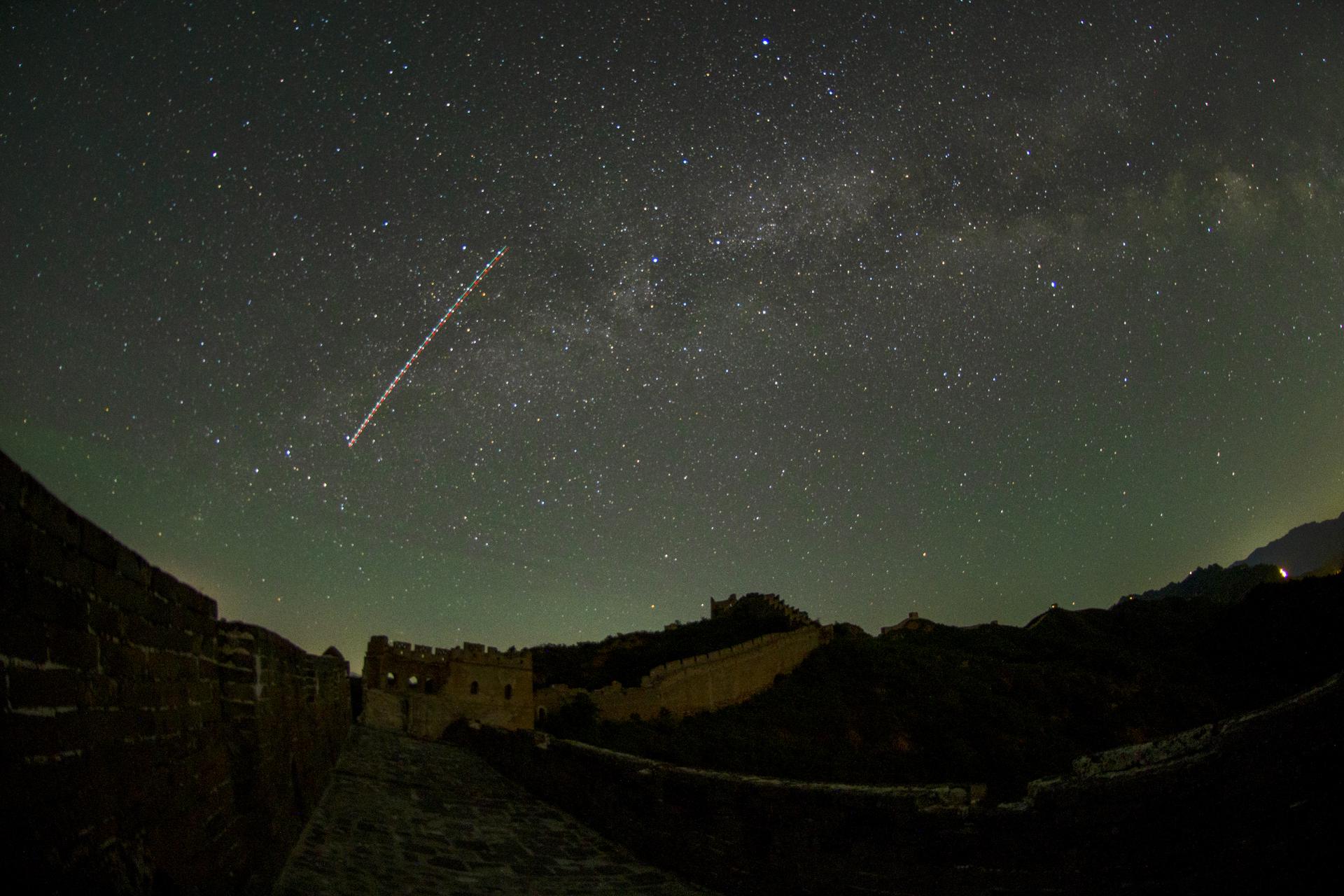 a meteor streaks through the sky
