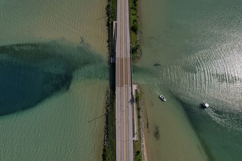 A stretch of road goes right between two beautifully clear lakes in Michigan