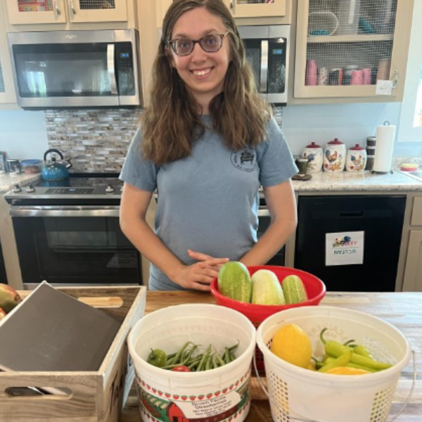 a girl in a kitchen with fresh produce