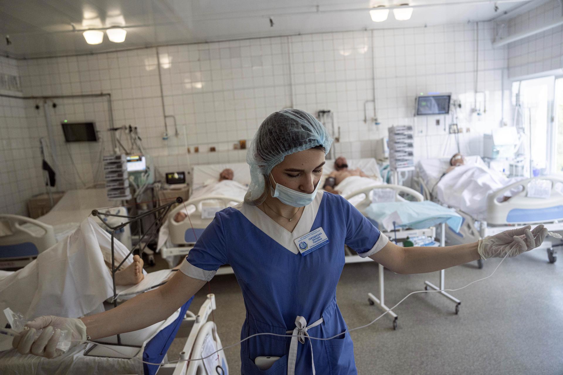 A nurse prepares to treat Ukrainian servicemen at the ICU of Mechnikov Hospital in Dnipro, Ukraine.