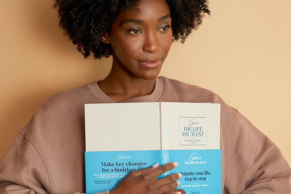 woman holding the Becoming Unstuck Journal