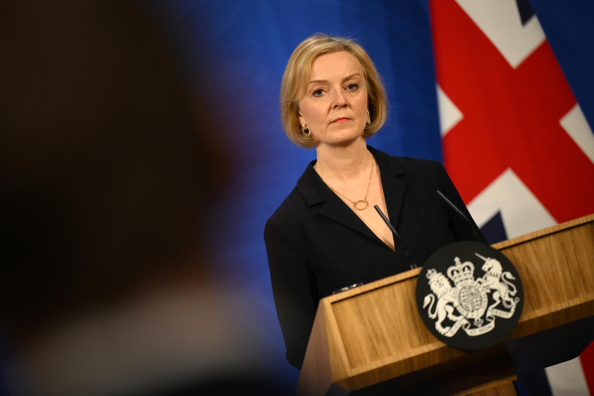 UK Prime Minister Liz Truss stands behind a podium.