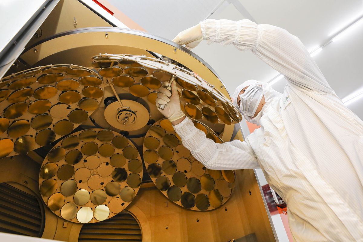 An employee works on the production line of semiconductors at a factory.