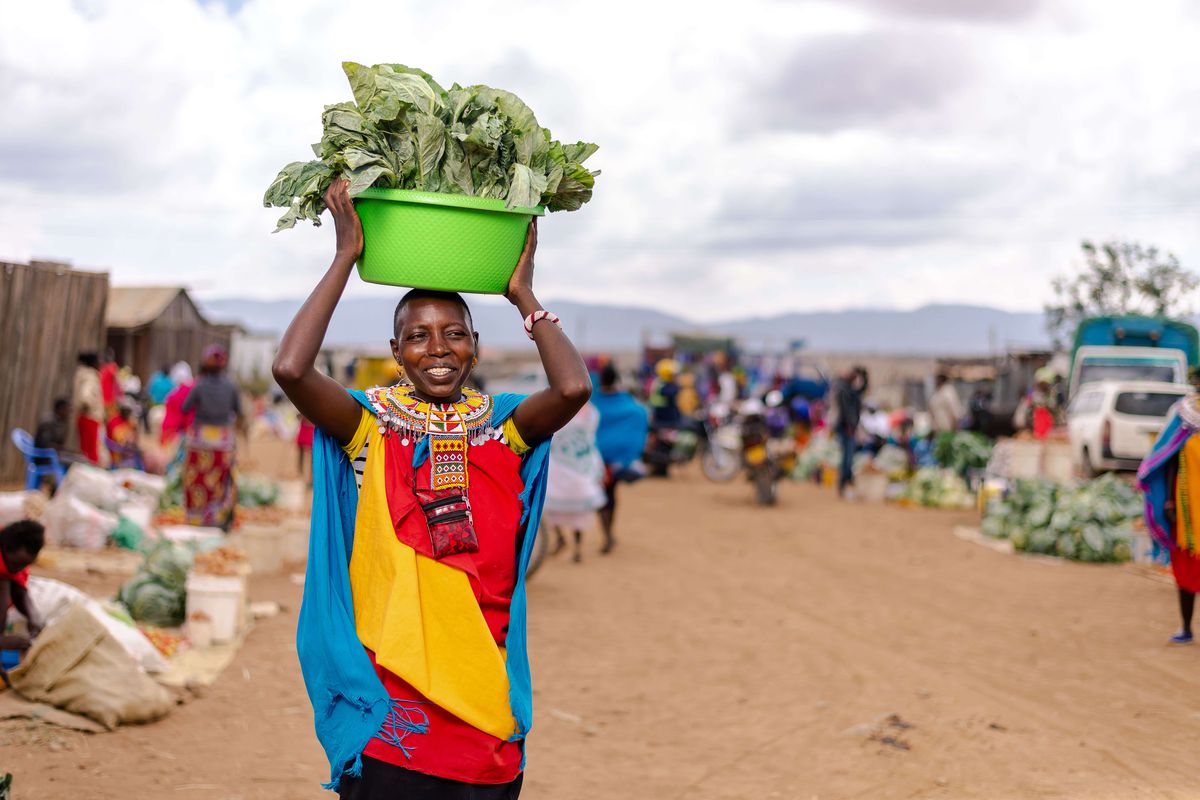 A woman carrying vegetables.