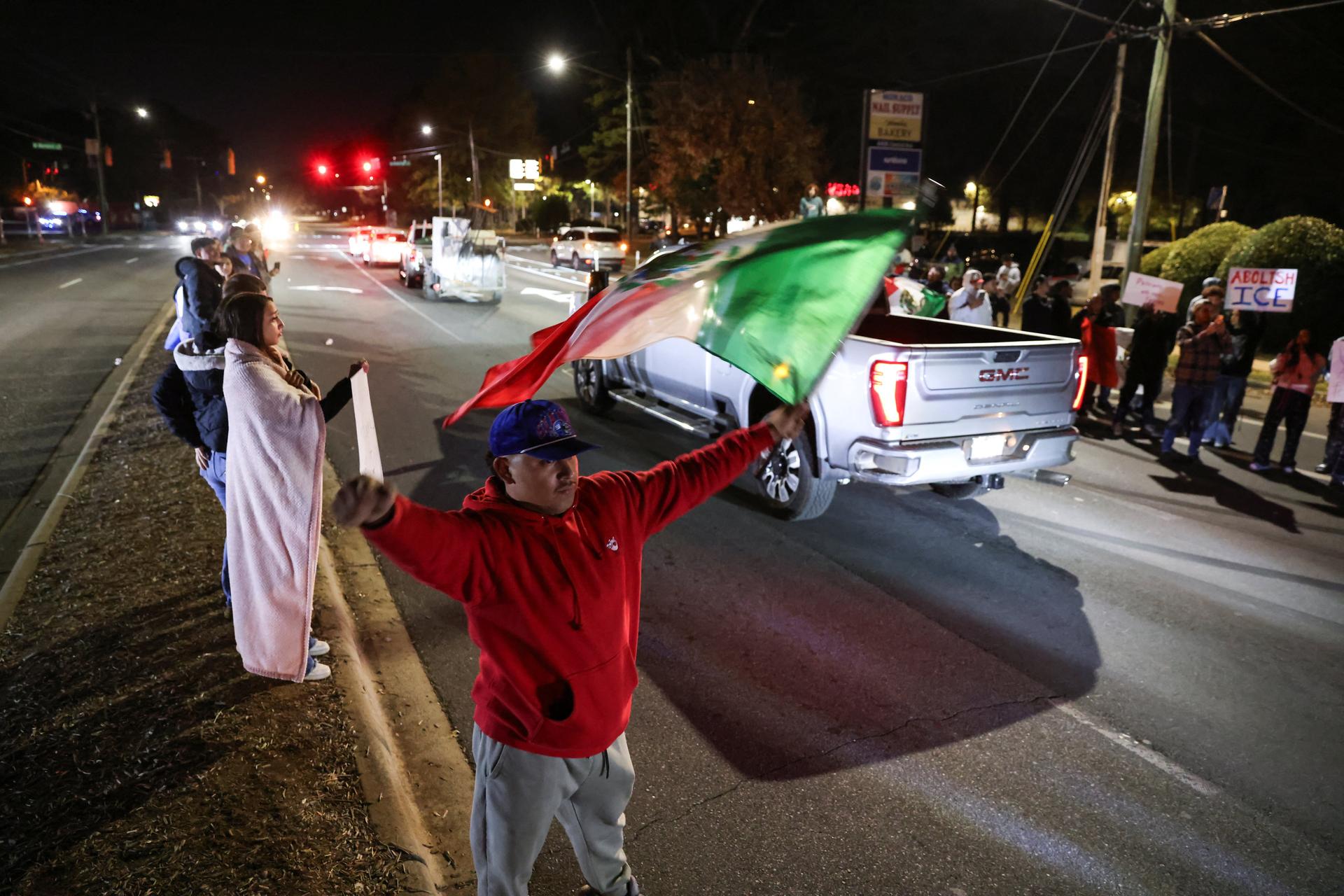 A demonstrator waves a Mexican flag as he participates in a protest in Charlotte, North Carolina.