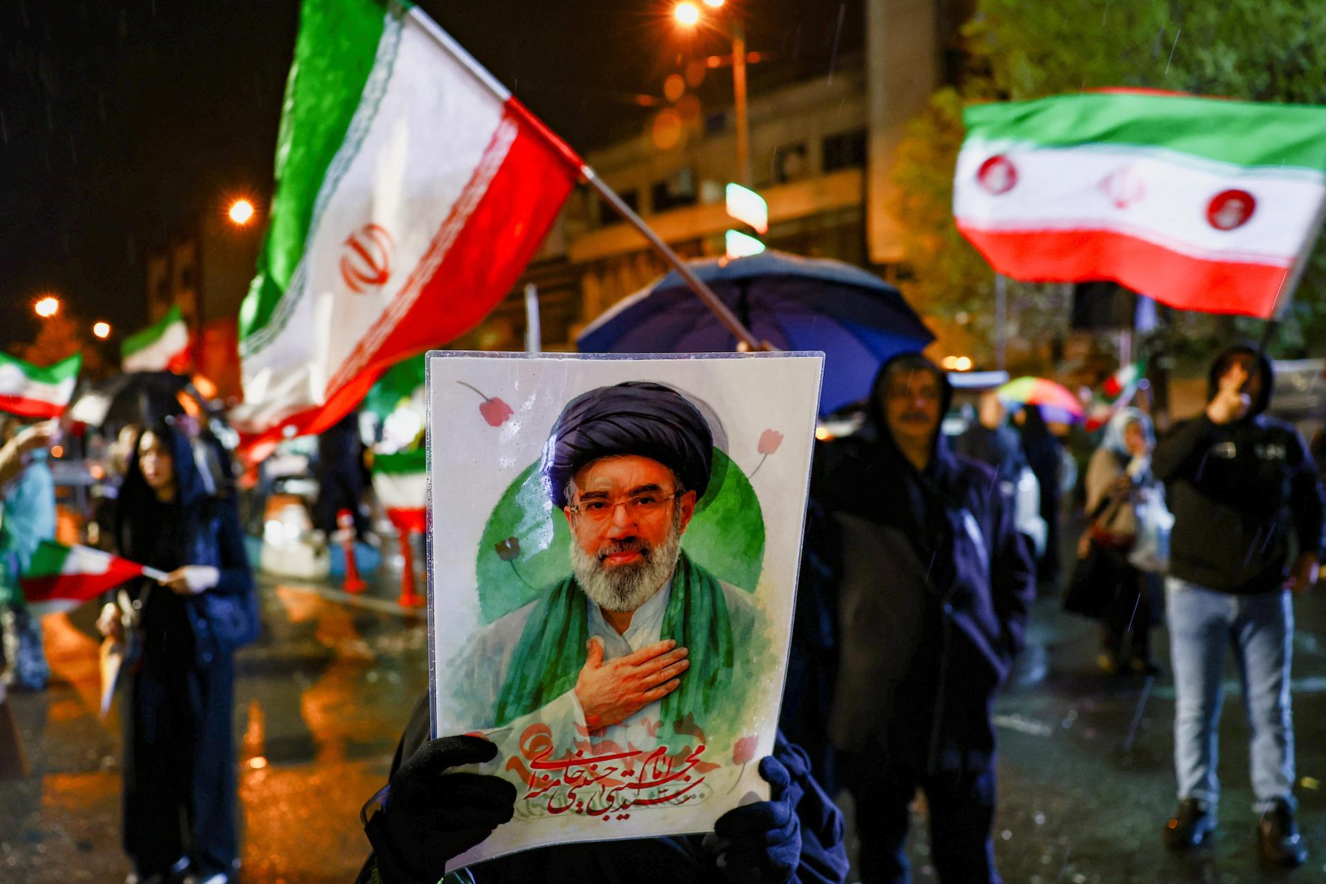 A woman holds a poster depicting Iran's new Supreme Leader Mojtaba Khamenei during an anti-US and anti-Israeli rally in Tehran