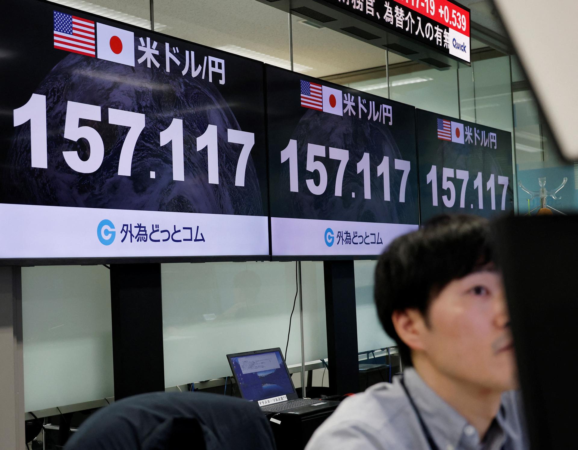 An employee of a foreign exchange trading company at a dealing room in Tokyo