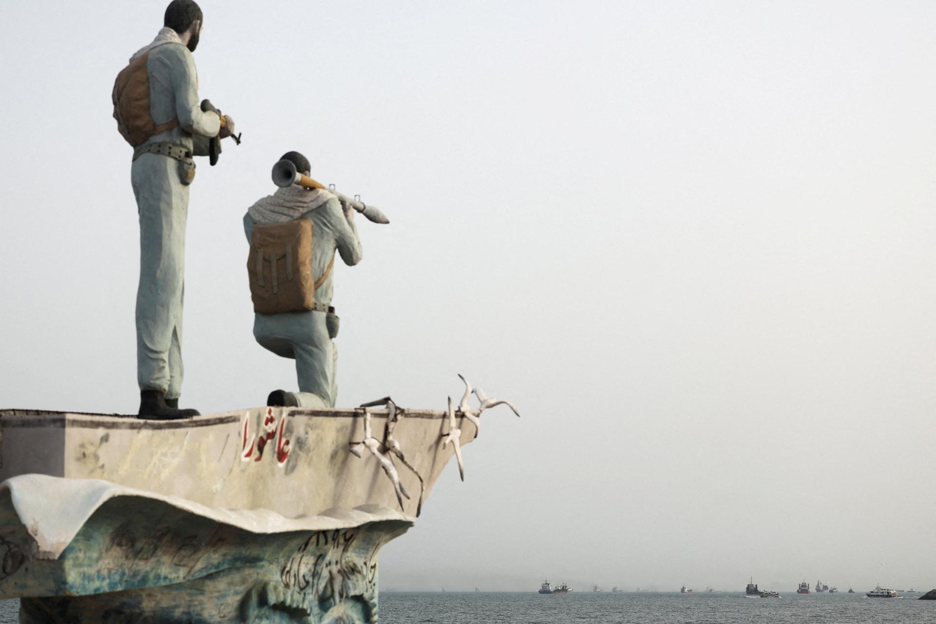 A statue of Iranian military members stands near the Strait of Hormuz
