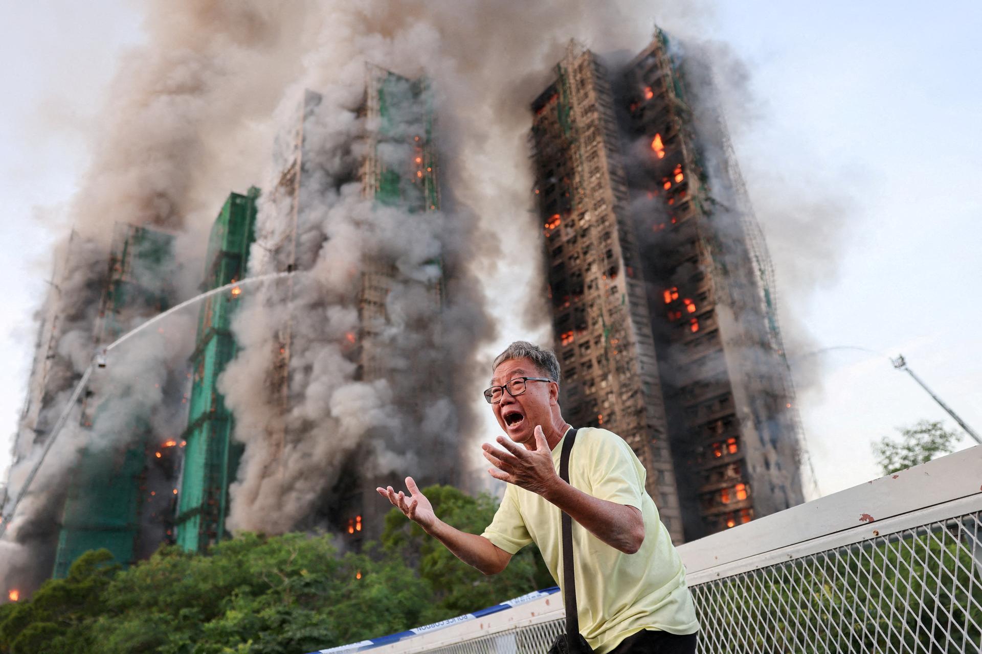 Wong reacts after claiming his wife is trapped inside Wang Fuk Court during a major fire, in Tai Po, Hong Kong, China, November 26, 2025. REUTERS/Tyrone Siu/ File Photo