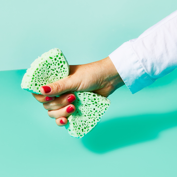 Woman with red nails holding sponge