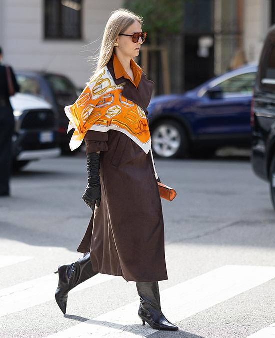 Street style image of woman walking in kitten heels