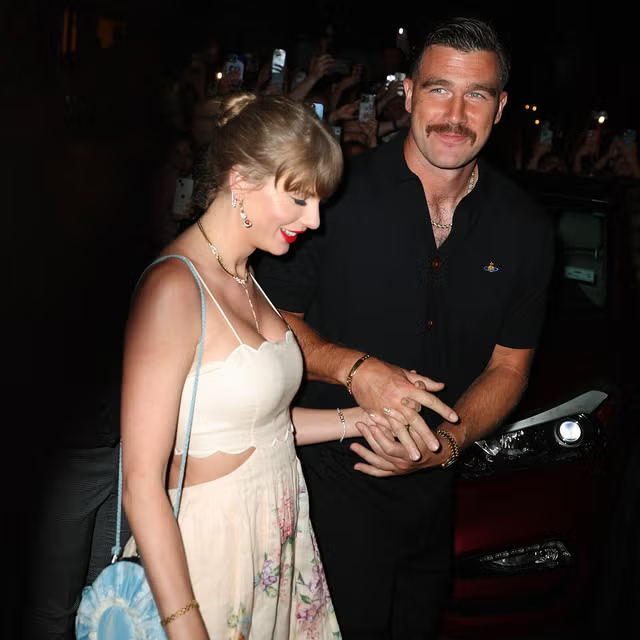 Taylor Swift and Travis Kelce holding hands