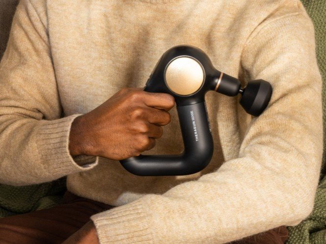 person using massage gun
