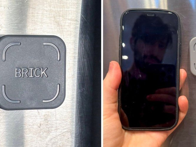 Person holding phone next to brick device