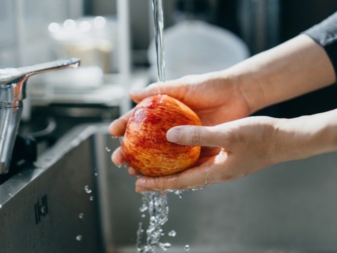 person washing an apple