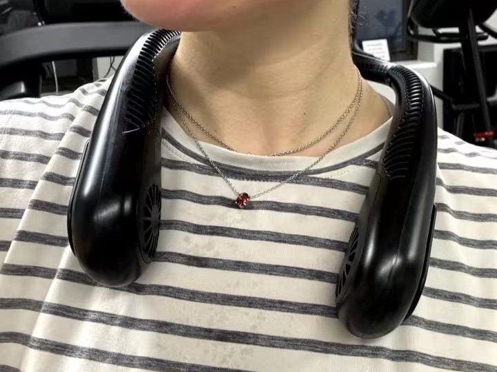 person wearing neck fan