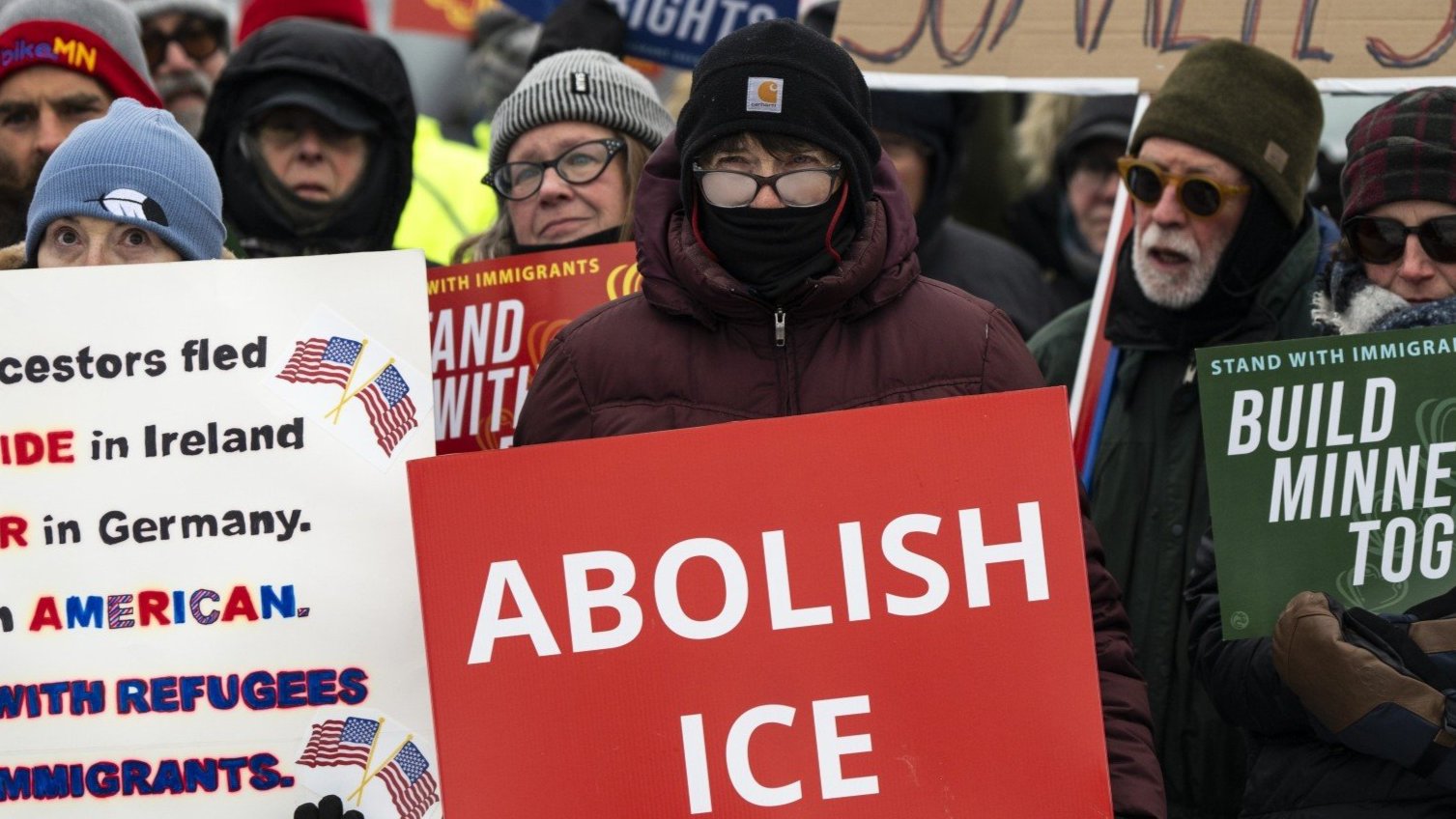 Protesters holding signs against ICE